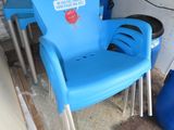 a blue plastic chair and a blue table in a garage