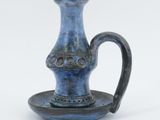 a small blue vase with a saucer on a plate