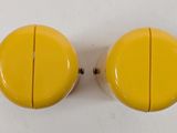 pair of yellow knobs on a white surface with a white background
