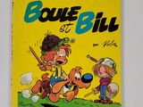 un livre jaune sur lequel figure l'image d'un garçon et d'un chien