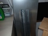 a stainless steel refrigerator in the corner of a kitchen