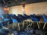 many blue chairs sitting in a row in a room