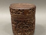 an old wooden box with carvings on it sitting on a table