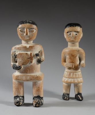 two carved figurines of a man and a woman