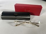 a pair of glasses sitting on top of a table next to a red box