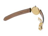 the back of a gold watch with a brown leather strap