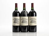 three bottles of wine sitting on top of a white table