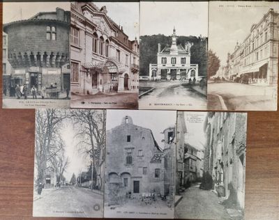 several old postcards of old buildings on a wooden table