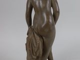 statue of a woman holding a bag in her right hand