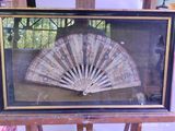 a picture of an old fan in a glass case