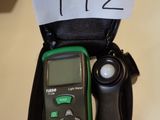 an image of a green and black meter sitting on top of a table