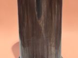an image of a black marble vase on a pink background