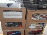 many boxes of clothing on a pallet in a warehouse