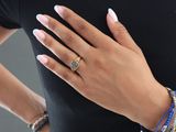 woman wearing a black shirt and blue bracelets with a gold ring on her finger