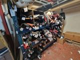 a lot of shoes that are on the shelves in the room