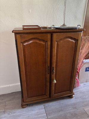 a wooden cabinet with a mirror on top of it
