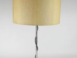 a black table lamp with a beige shade on top of it