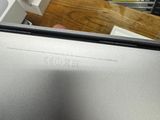 a laptop computer sitting on top of a wooden table