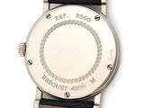 a close up of a wrist watch with a black strap