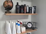 a shelf that has many different types of hair products on it