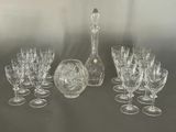 a lot of wine glasses and a decanter on the table