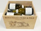 trois bouteilles de vin dans un coffret en bois sur une table