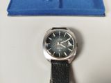 a watch that is sitting on a table next to a blue box