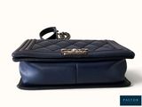 a black purse with a ring on top of it