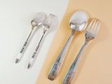 two forks and two spoons sitting on a table