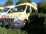several ambulances are parked in a grassy field with trees in the background