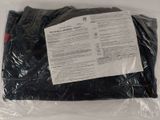 a bag of black clothing on a white surface