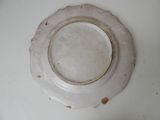 a white plate with a brown rim sitting on a table
