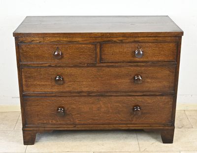 a wooden chest of drawers on a tiled floor