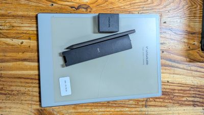 a tablet computer sitting on top of a wooden table