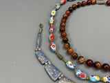 three necklaces that are on a table next to each other