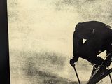 a black and white photo of a man on skis