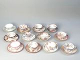 many cups and saucers sitting on a table