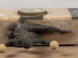 a figurine of a man sitting on top of a suitcase