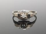 an image of a diamond ring on a reflective surface