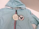 a light blue jacket with a red, white, and blue stripe on it