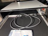 a laptop computer sitting on top of a conveyor belt