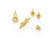 a set of five gold plated brass screws on a white background