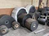 many rolls of black rubber on the floor
