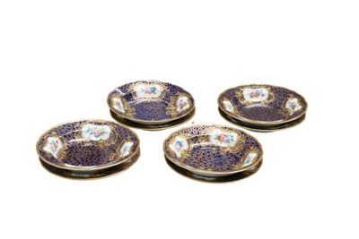 four purple and white plates with flowers on them on a white surface