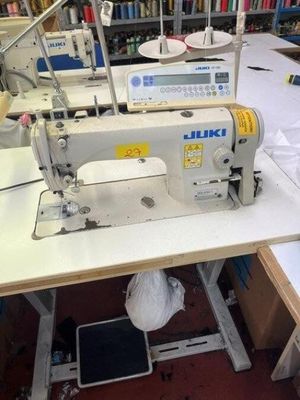a sewing machine that is sitting on a table in a room