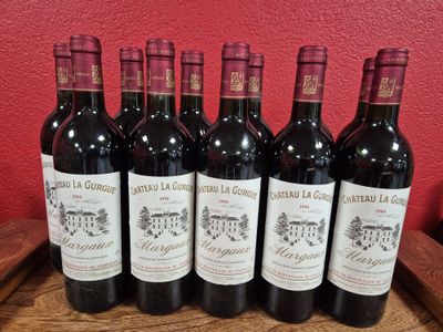 six bottles of red wine are lined up on a wooden tray