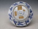 a blue and white plate with a picture of a cat on it