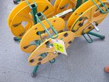 a lot of yellow reels on a cart on the ground