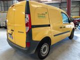 a yellow van that is parked in a garage