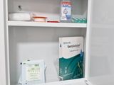 a medicine cabinet in the corner of a bathroom